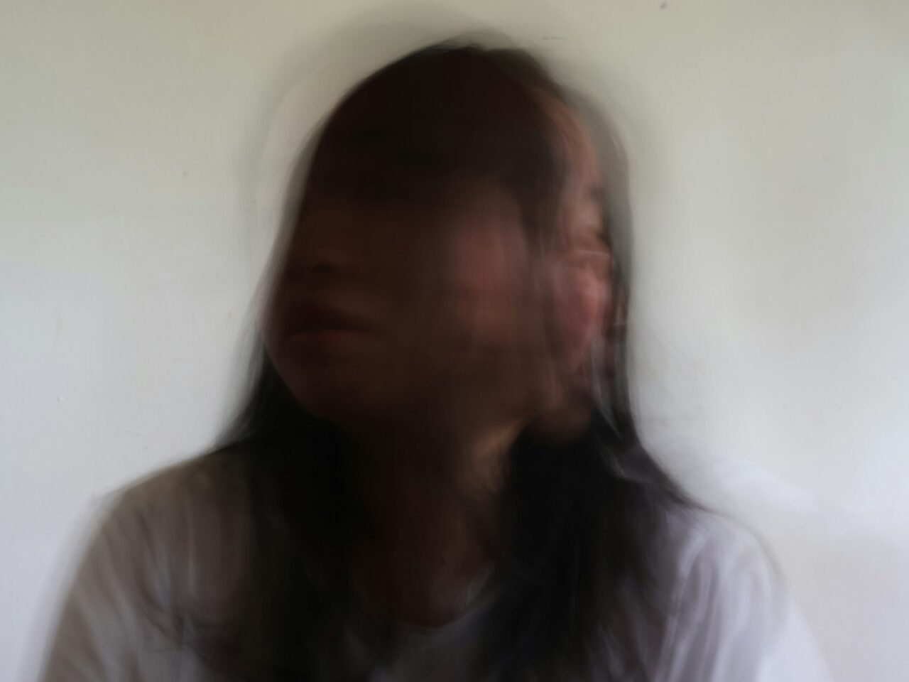 Blurred portrait of a person against a white background